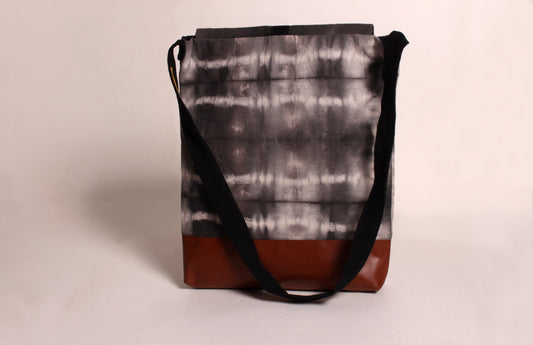 Back view of Stone Grey Artist Bag made from cotton fabric with faux leather, a magnetic snap closure, and a pocket