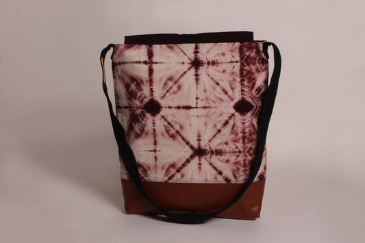 Back view of Brown Ripple Artist Bag made from cotton fabric with faux leather, a magnetic snap closure, and a pocket