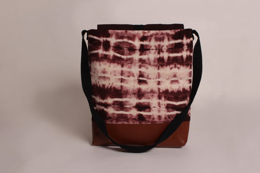 Back view of Earthy Brown Artist Bag made from cotton fabric with faux leather, a magnetic snap closure, and a pocket