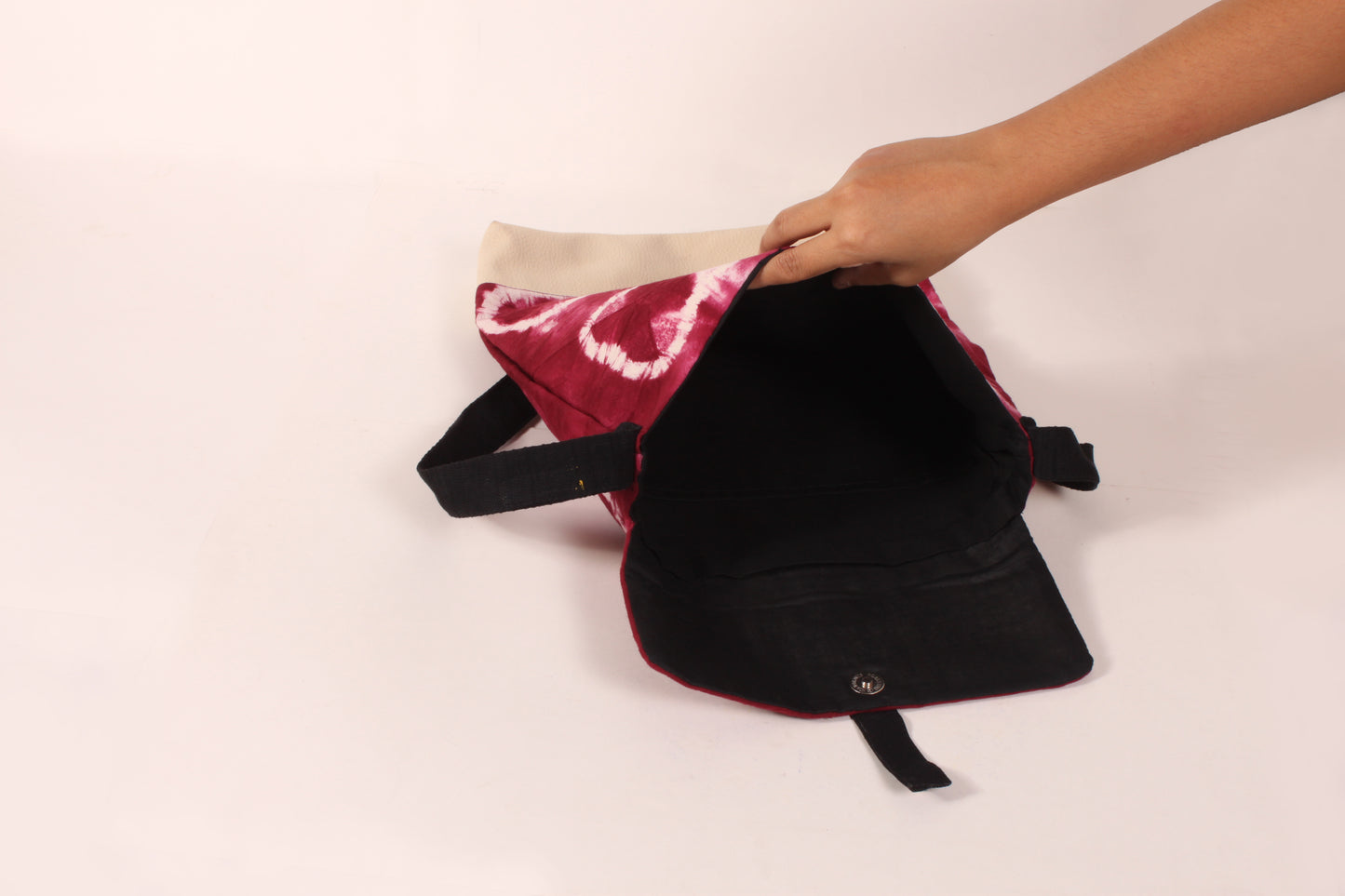 Interior view of Maroon Flower Artist Bag made from cotton fabric with faux leather, a magnetic snap closure, and a pocket