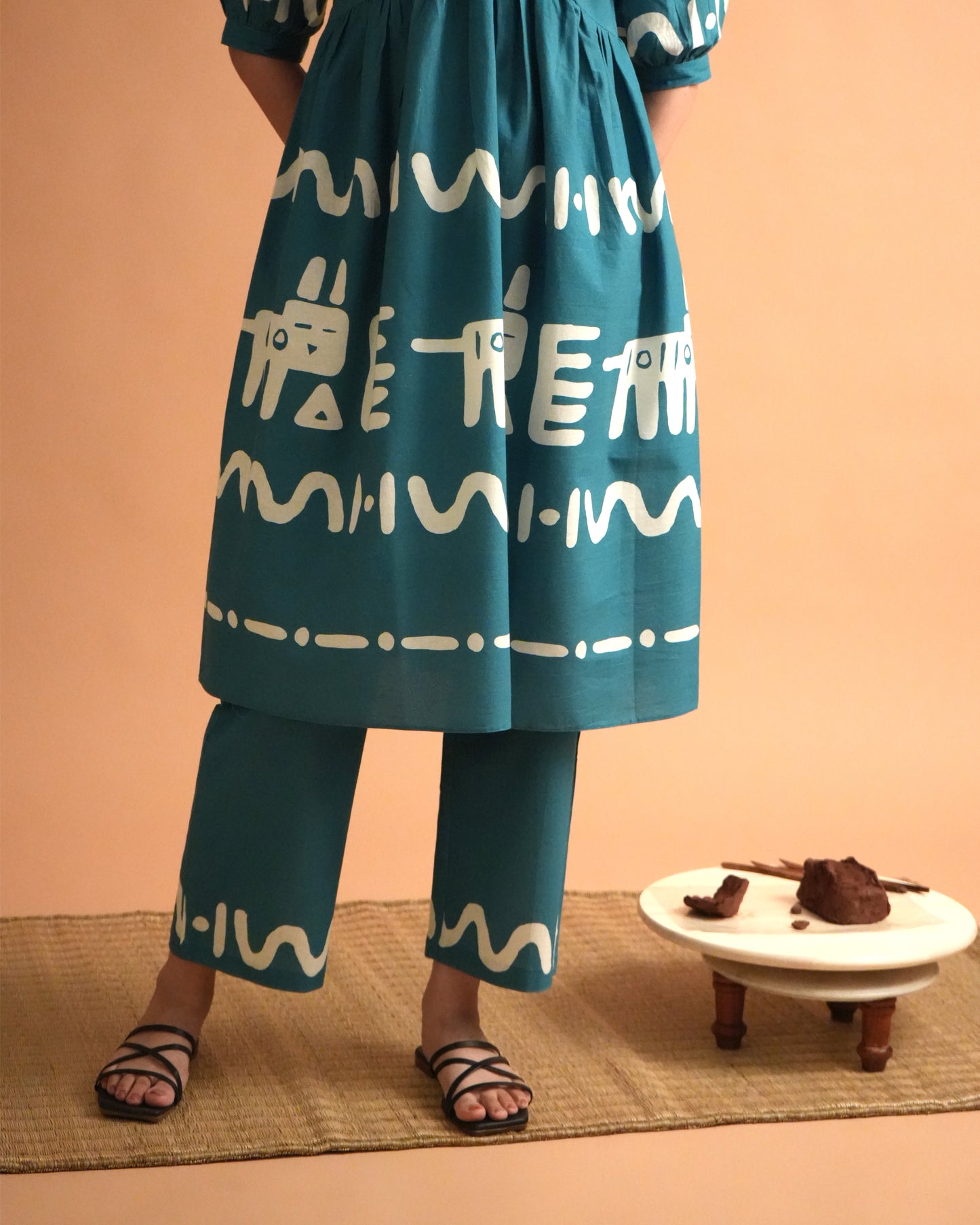 Fabric close-up showing tribal prints and teal cotton texture of the Polu Co-ord Set