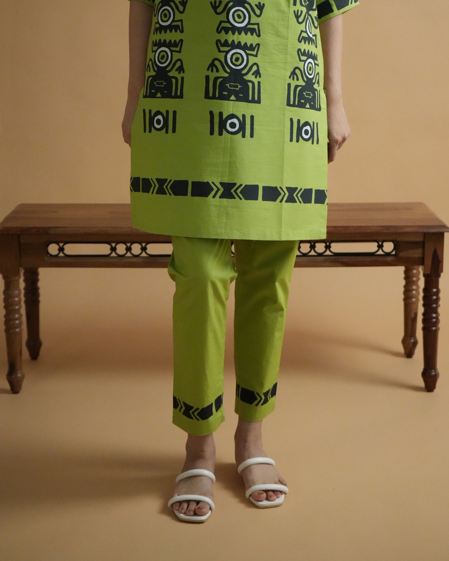 Fabric close-up of tribal motifs on leaf green cotton from the Amali Cotton Kurta Co-ord Set