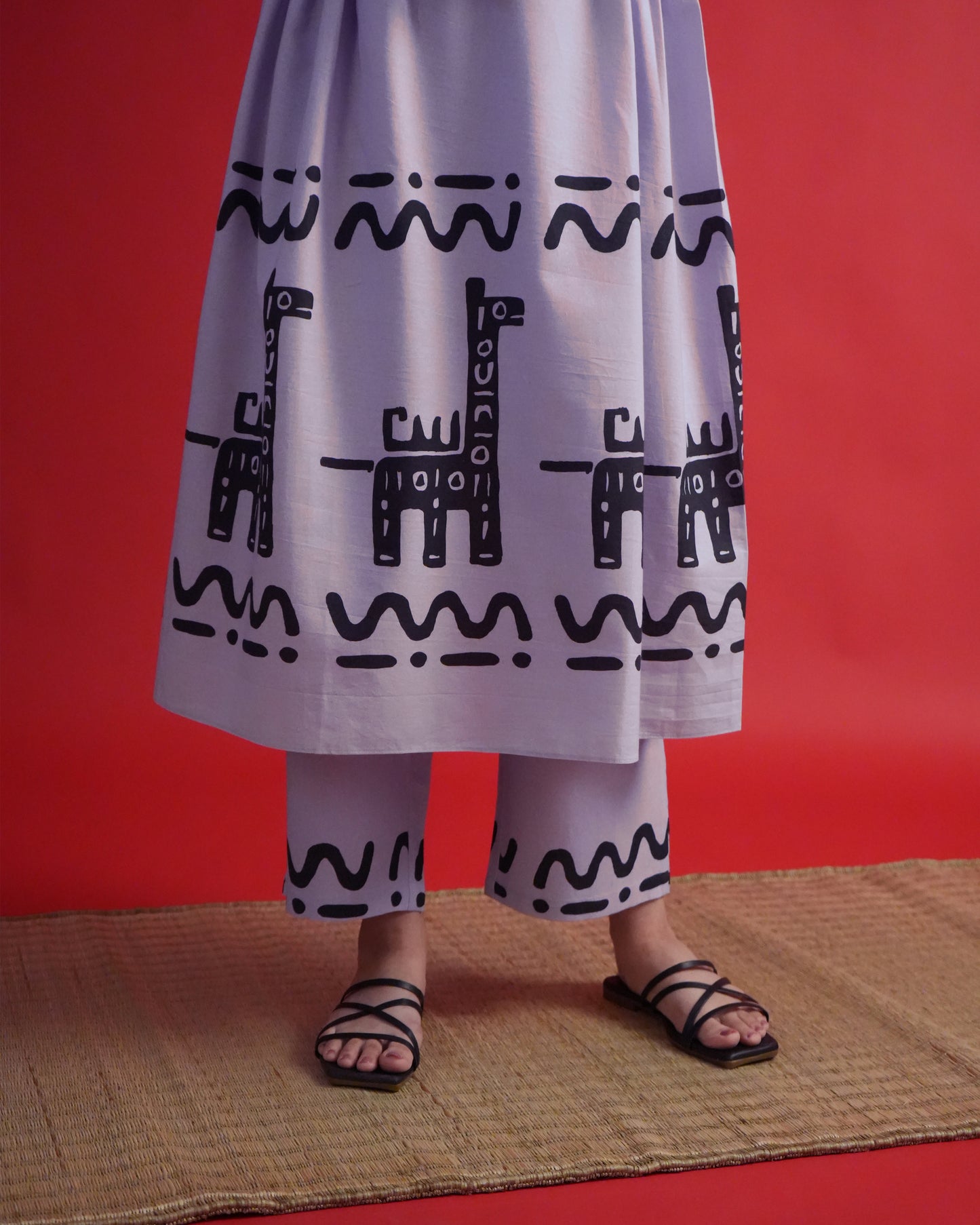 Fabric close-up showing tribal motifs on lavender cotton from the Usu Cotton Co-ord Set