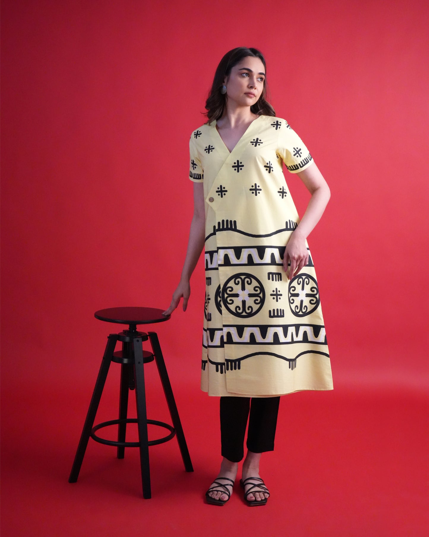 Model wearing the Kiiro Cotton Kurta Co-ord Set, showcasing the pastel yellow tribal wrap kurta with contrasting black pants