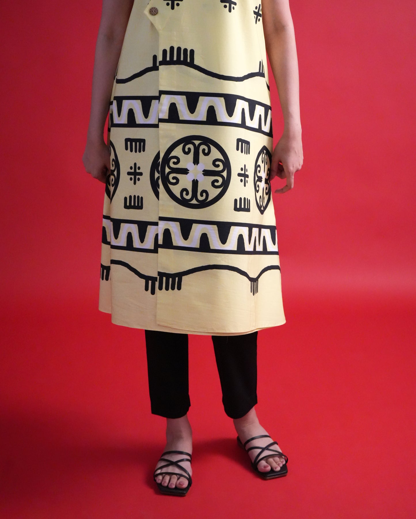 Close-up of the tribal print details on the pastel lemon yellow cotton wrap kurta from the Kiiro Co-ord Set