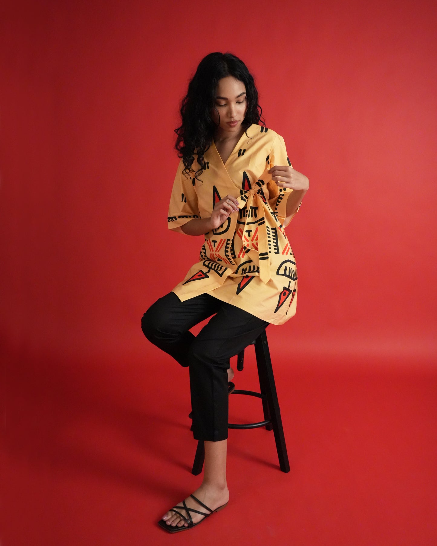 Model wearing Owu Cotton Co-ord Set with pastel orange kurta, tribal prints, tie detail, and black pants