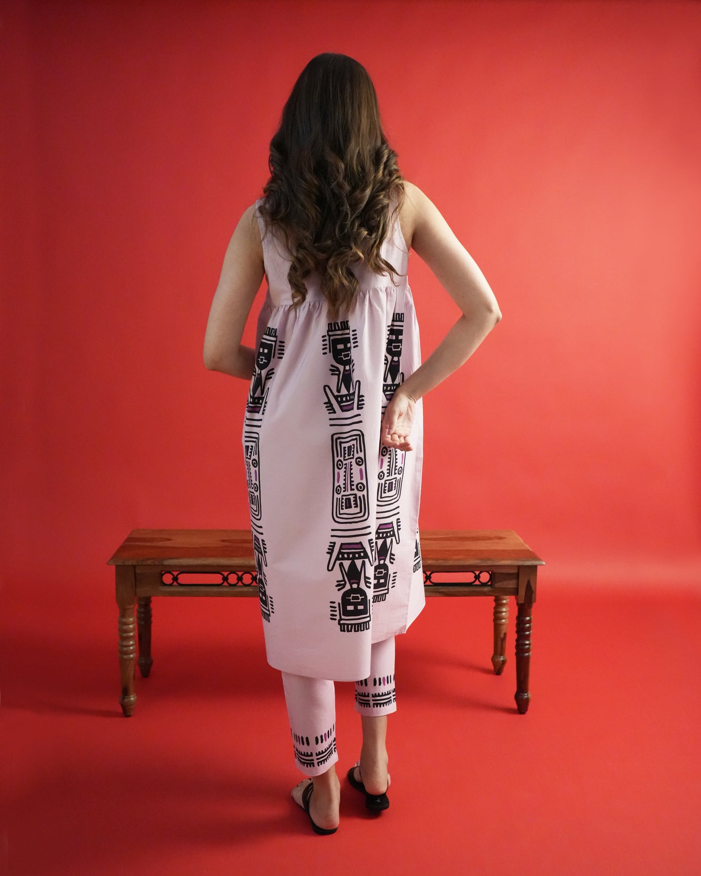 Back view of Merah Cotton Kurta Co-ord Set in powder pink showing sleeveless kurta and slim trousers