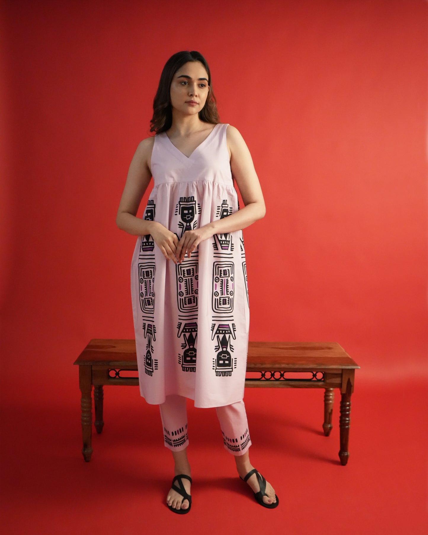 Front view of Merah Cotton Co-ord Set in powder pink with sleeveless empire-line kurta, tribal motifs, and slim pants