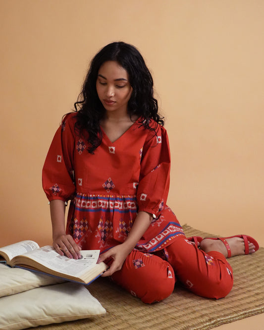 Model wearing Ula Cotton Co-ord Set with red gathered waistline kurta, shell-detailed puff sleeves, and slim pants