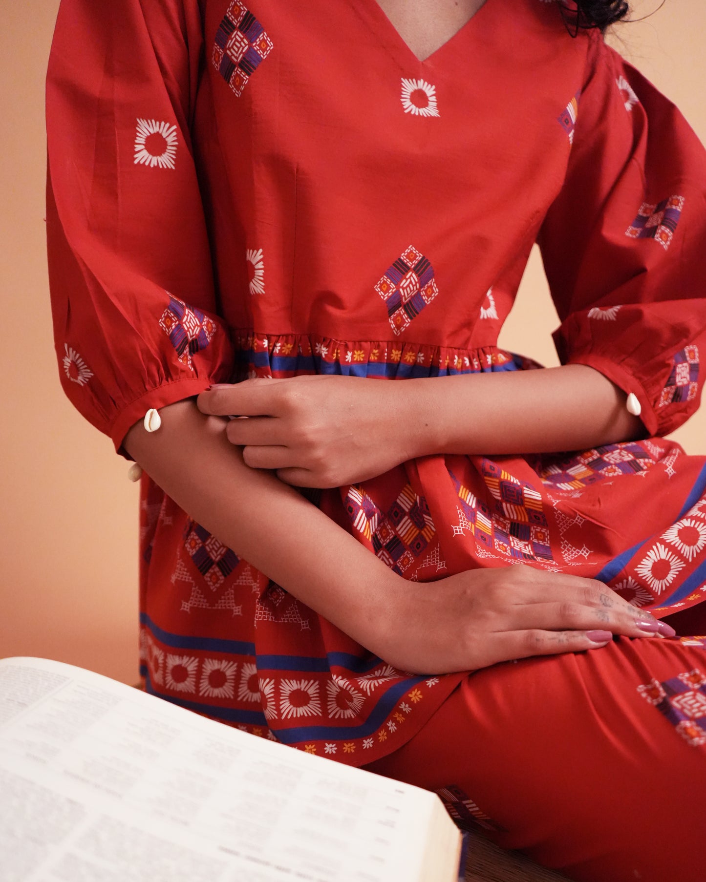 Detailed shot of shell-detailed puff sleeve in red cotton from the Ula Cotton Kurta Co-ord Set