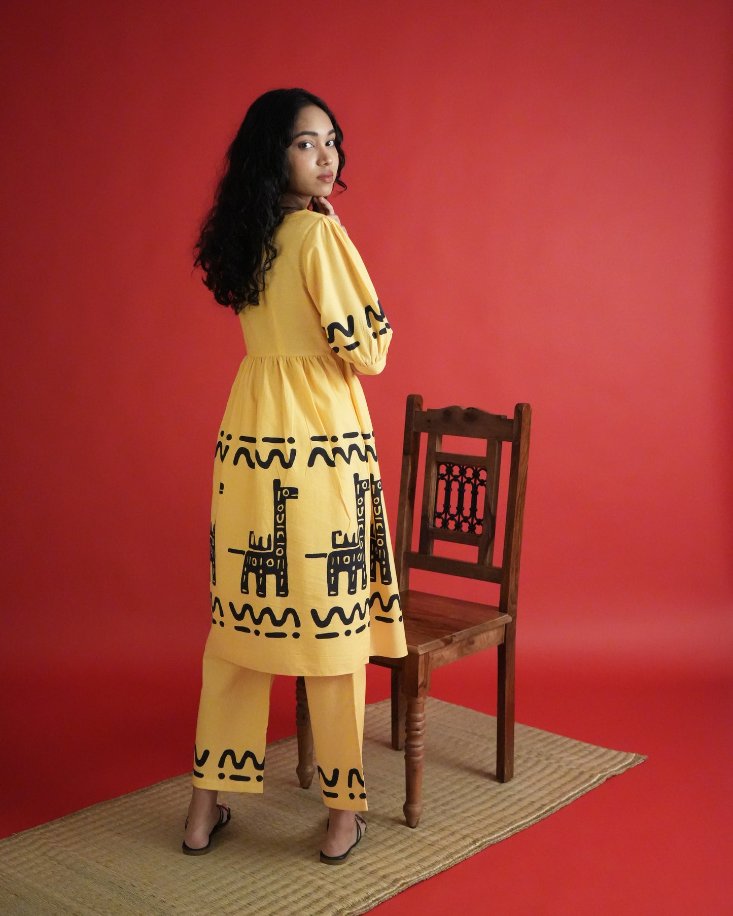 Back view of Sikwu Cotton Kurta Co-ord Set in mango yellow cotton showing empire-line kurta and wide-leg pants