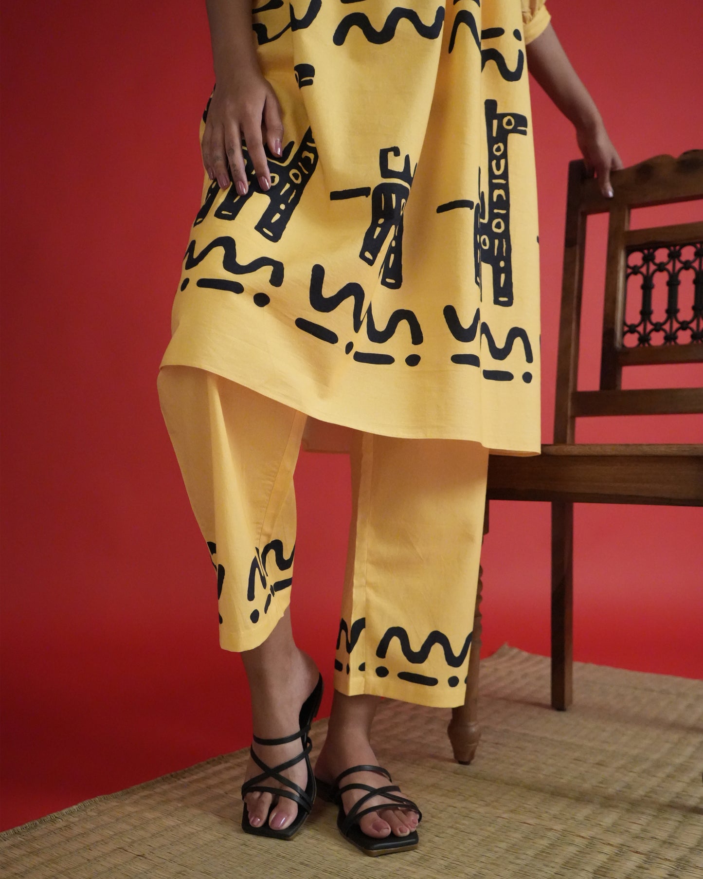 Fabric close-up of tribal print on mango yellow cotton from the Sikwu Cotton Kurta Co-ord Set