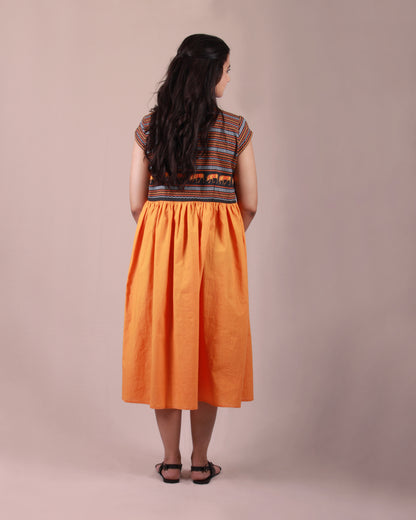 Back view of orange Amphora Pottery Dress in cotton fabric with printed yoke detail and cap sleeves