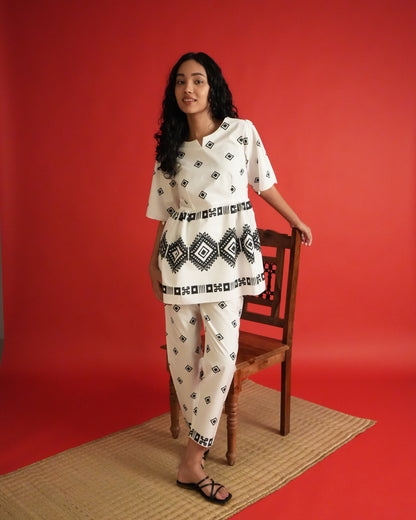 Front view of Shiro Cotton Co-ord Set in black and white with shell-detailed flared sleeves, tribal motifs, and slim pants