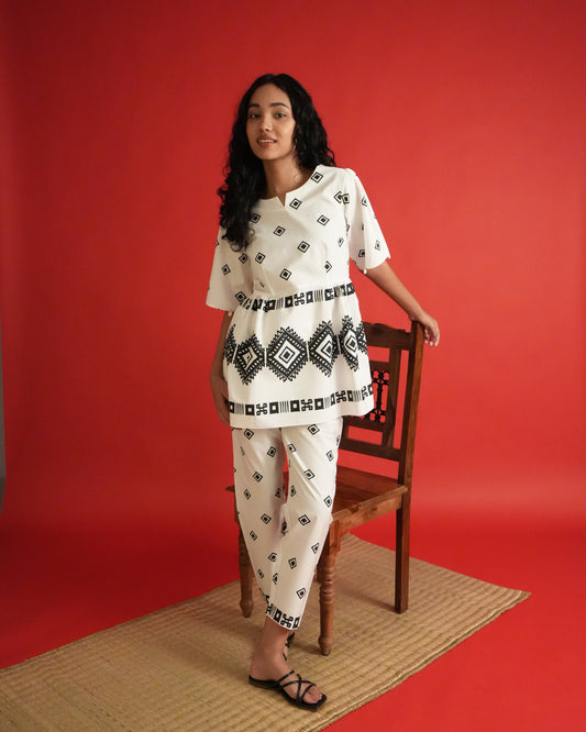 Front view of Shiro Cotton Co-ord Set in black and white with shell-detailed flared sleeves, tribal motifs, and slim pants