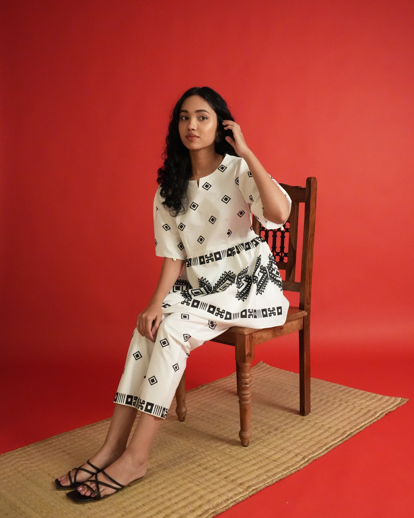 Side view of Shiro Cotton Co-ord Set in black and white with tribal motifs, flared sleeves, and slim pants.