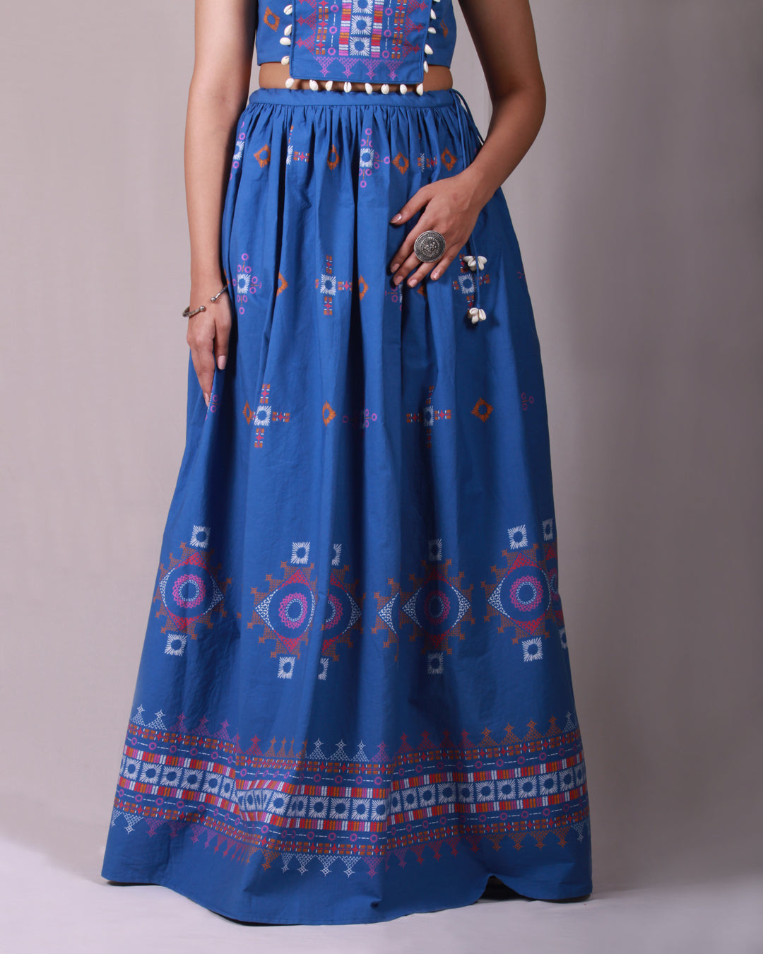 Skirt closeup of Blue Lambada Co-ord Set in cotton with chic cap sleeves, playful tassel and shell details