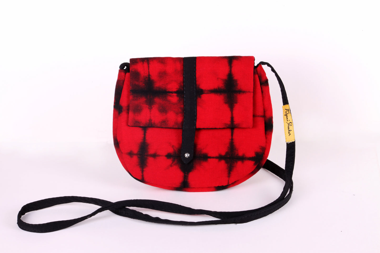 Front view of Red Check Sling Bag in cotton tie dye fabric with a magnetic snap closure and an interior pocket