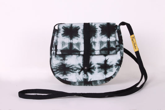 Front view of Black And White Check Sling Bag in cotton tie dye fabric with a magnetic snap closure and an interior pocket