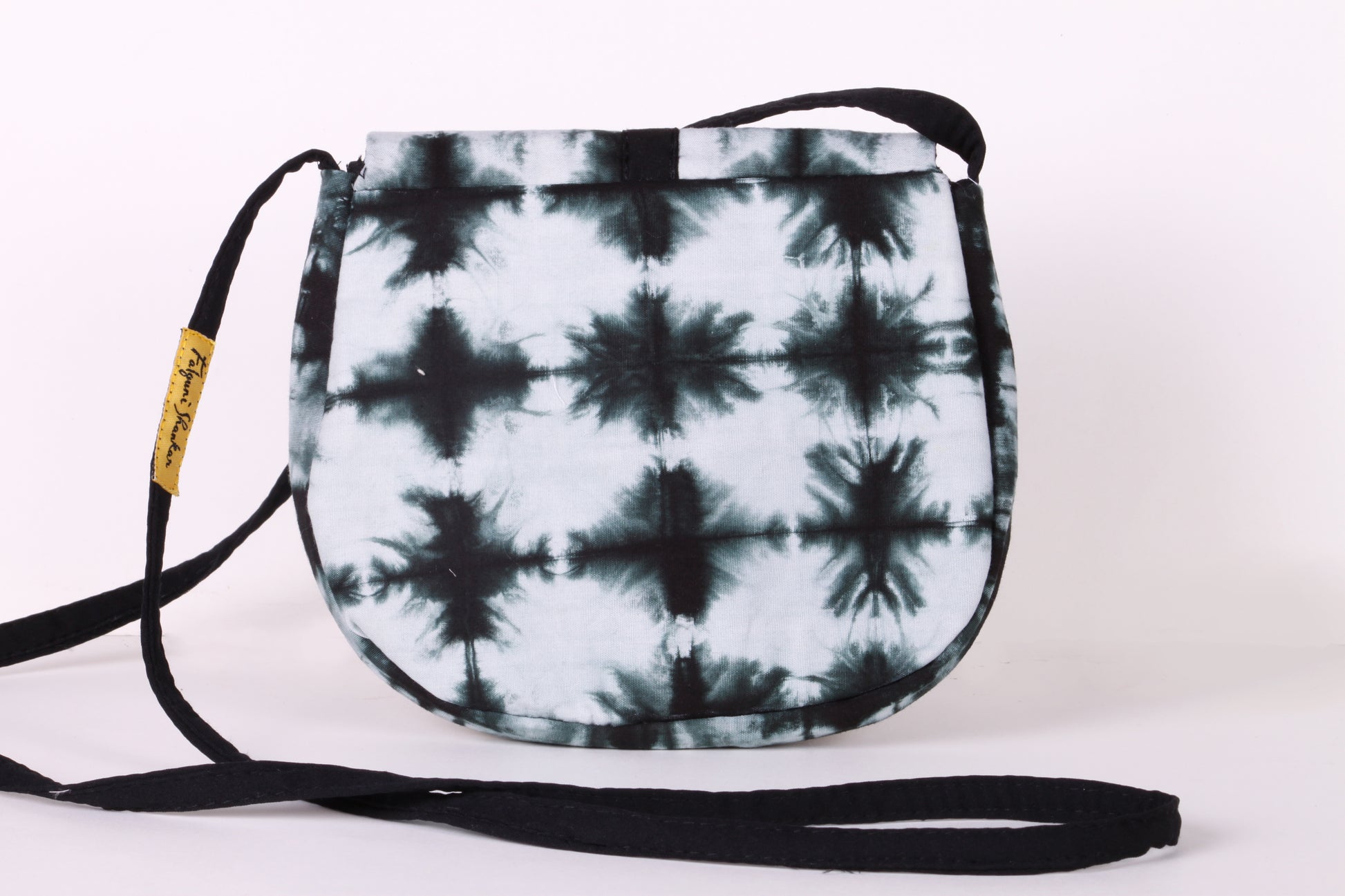 Back view of Black And White Check Sling Bag in cotton tie dye fabric with a magnetic snap closure and an interior pocket