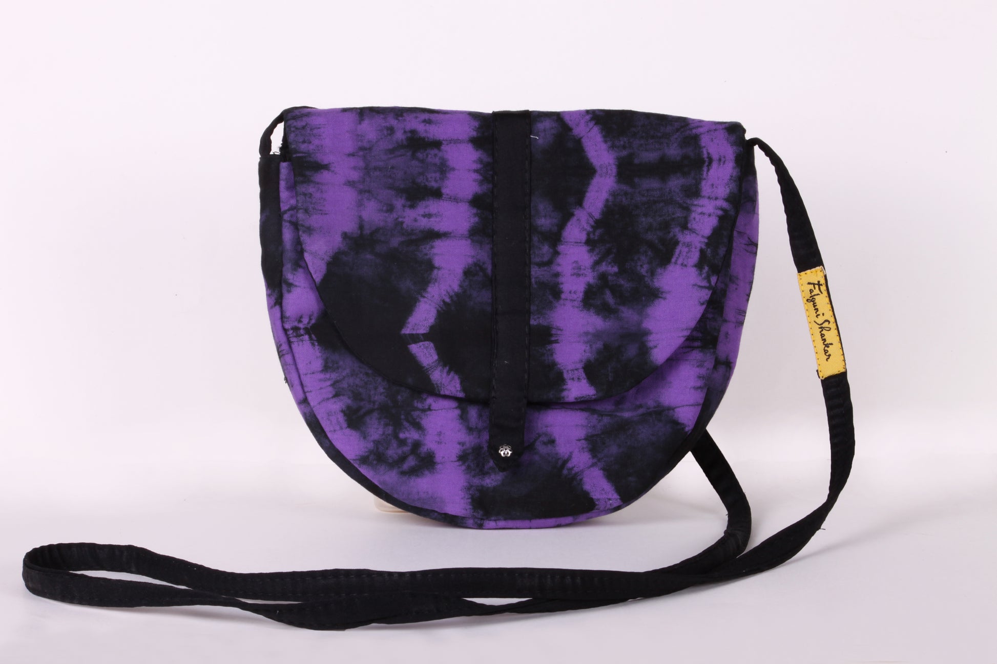 Front view of Violet Taco Sling Bag in cotton tie dye fabric with a magnetic snap closure and an interior pocket