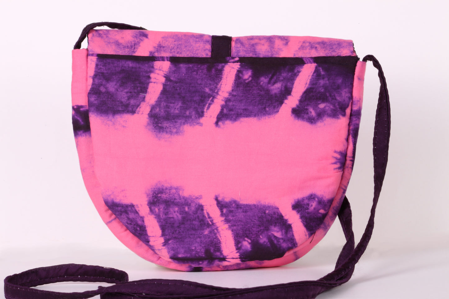 Back view of Pink Taco Sling Bag in cotton tie dye fabric with a magnetic snap closure and an interior pocket