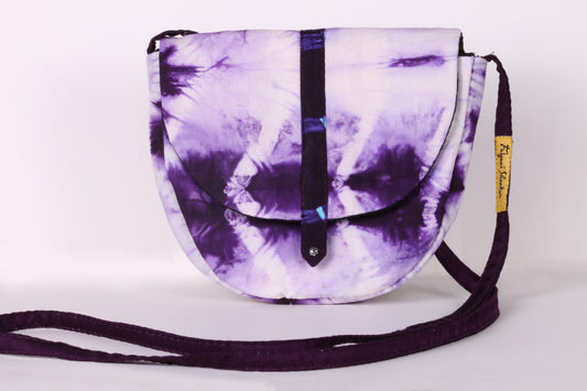 Front view of White Taco Sling Bag in cotton tie dye fabric with a magnetic snap closure and an interior pocket