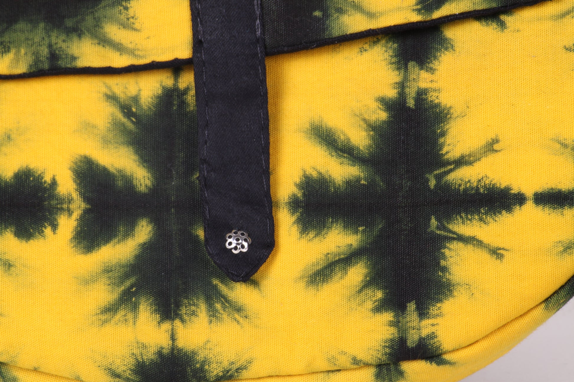 Closeup view of Yellow Check Sling Bag in cotton tie dye fabric with a magnetic snap closure and an interior pocket