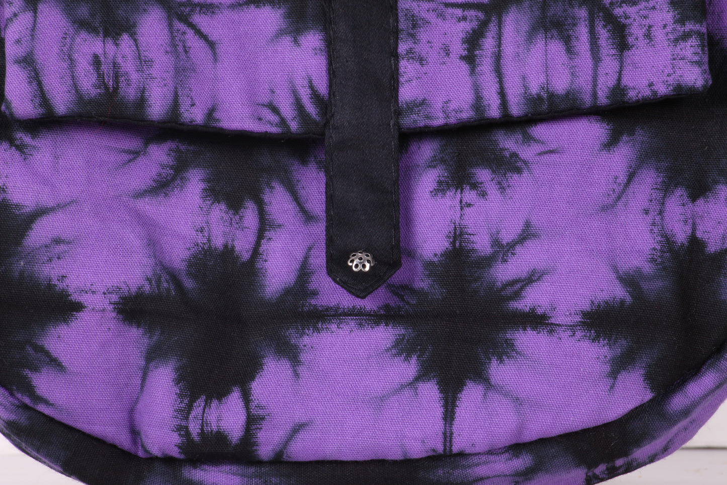 Closeup view of Violet Check Sling Bag in cotton tie dye fabric with a magnetic snap closure and an interior pocket