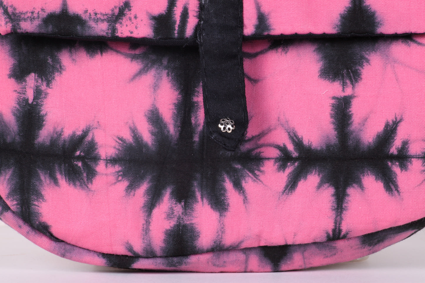 Closeup view of  Pink Check Sling Bag in cotton tie dye fabric with a magnetic snap closure and an interior pocket