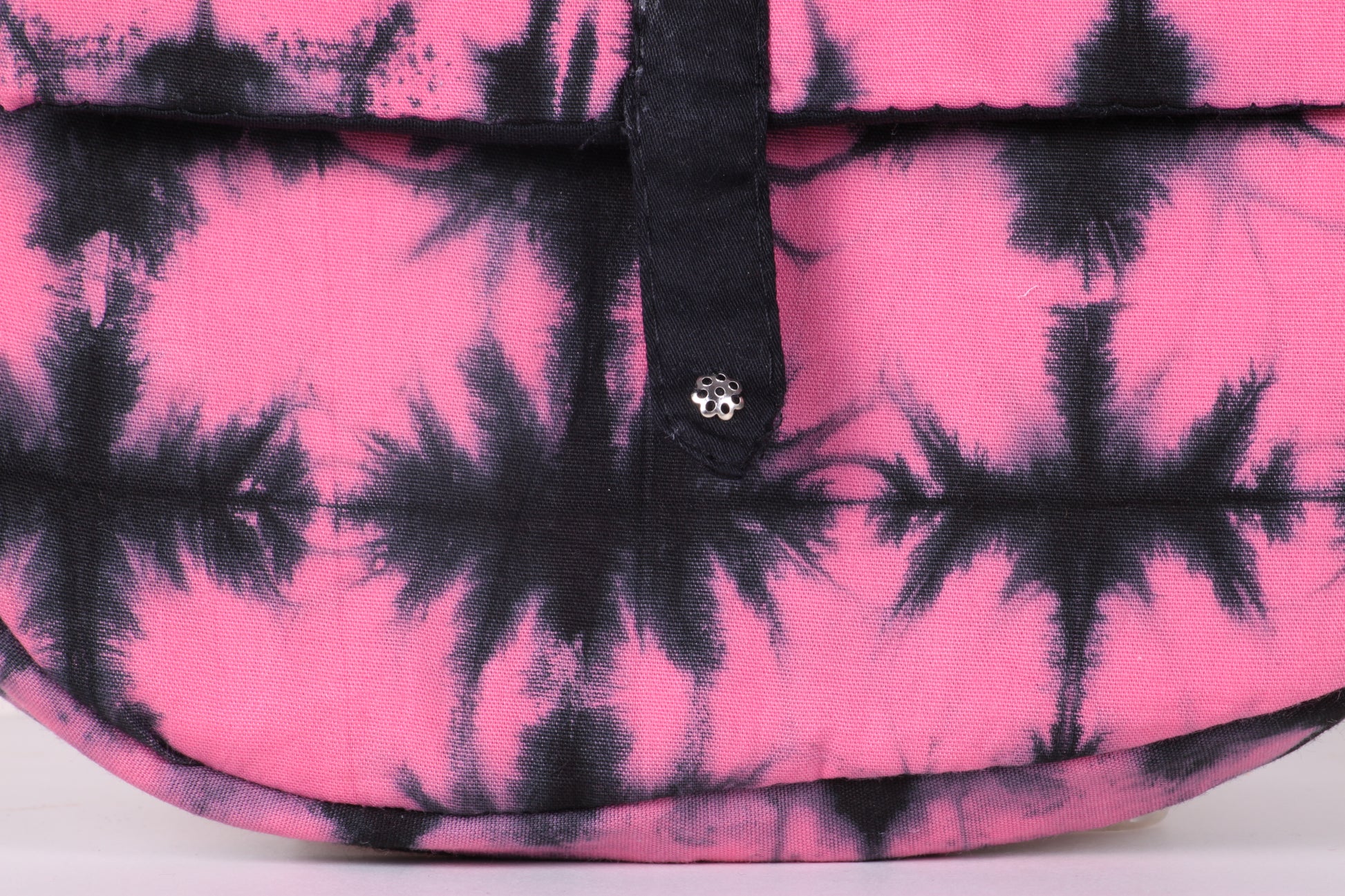 Closeup view of  Pink Check Sling Bag in cotton tie dye fabric with a magnetic snap closure and an interior pocket