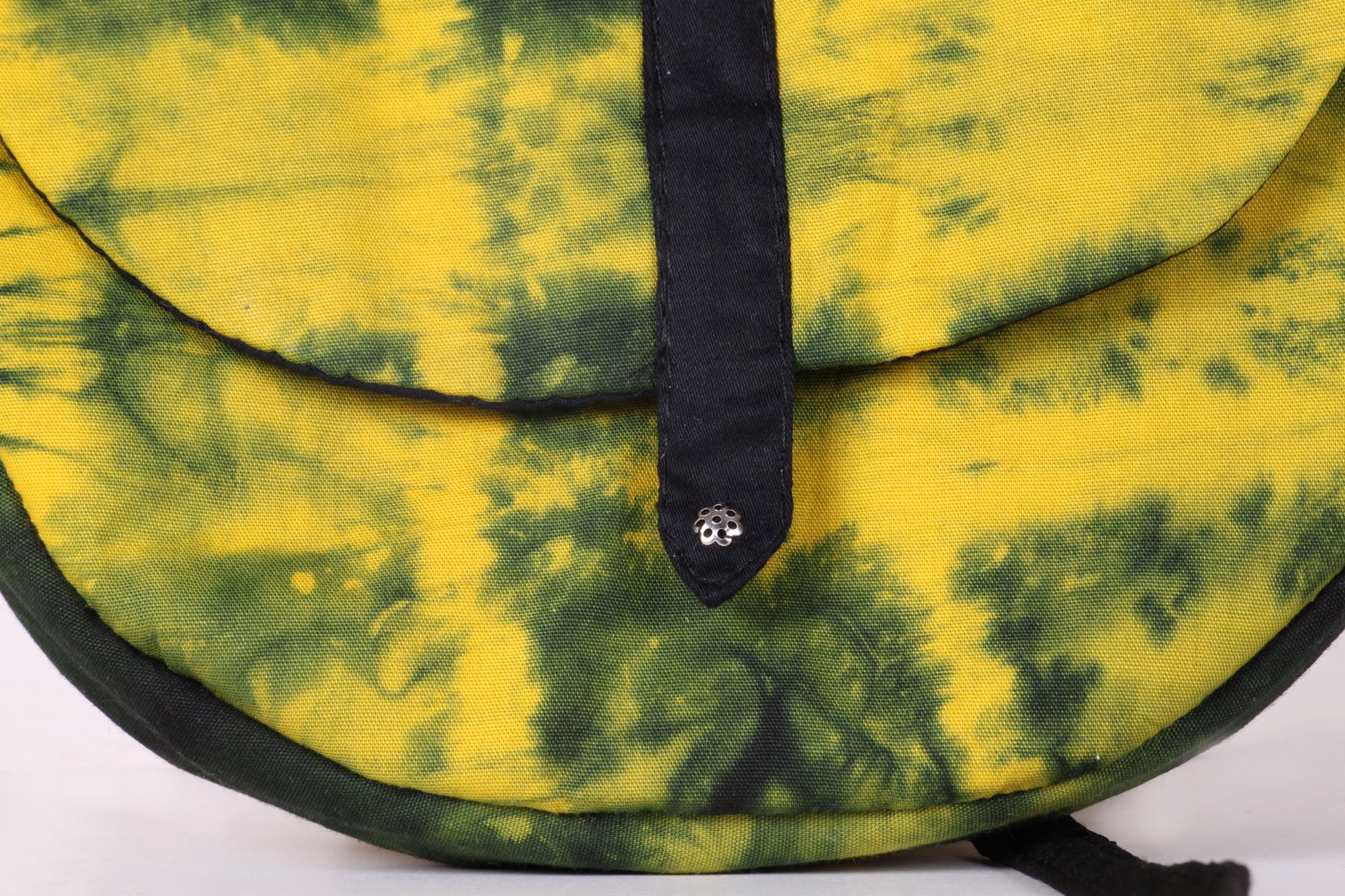 Closeup view of Yellow Taco Sling Bag in cotton tie dye fabric with a magnetic snap closure and an interior pocket