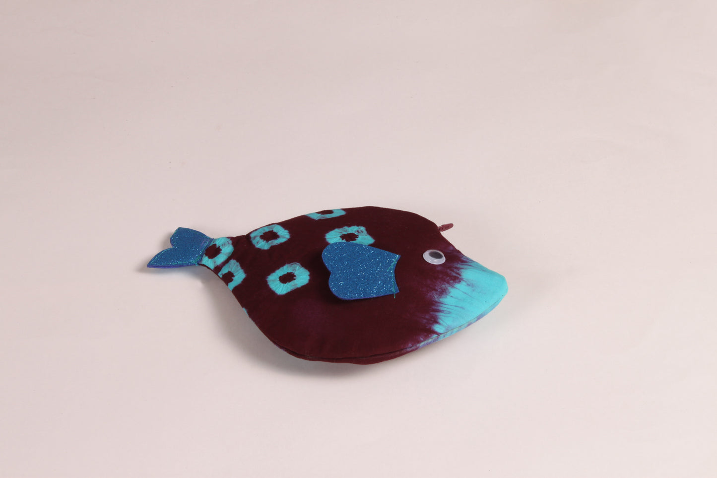 Flat view of Maroon Pomfret Fish Pouch made from cotton fabric with a zip closure