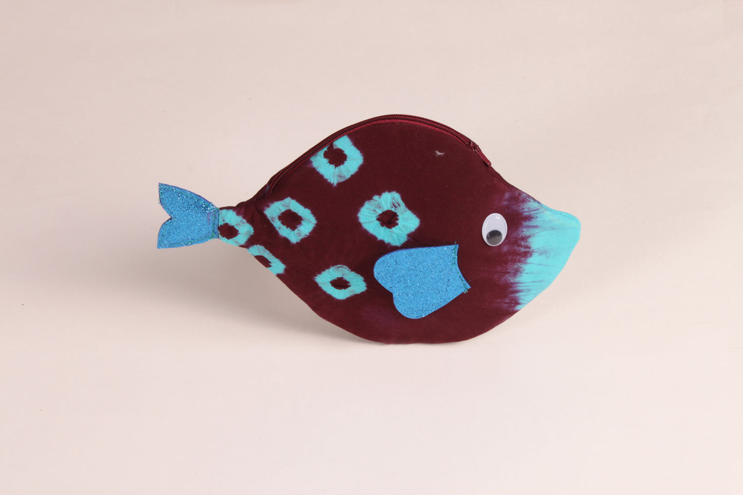 Side view of Maroon Pomfret Fish Pouch made from cotton fabric with a zip closure