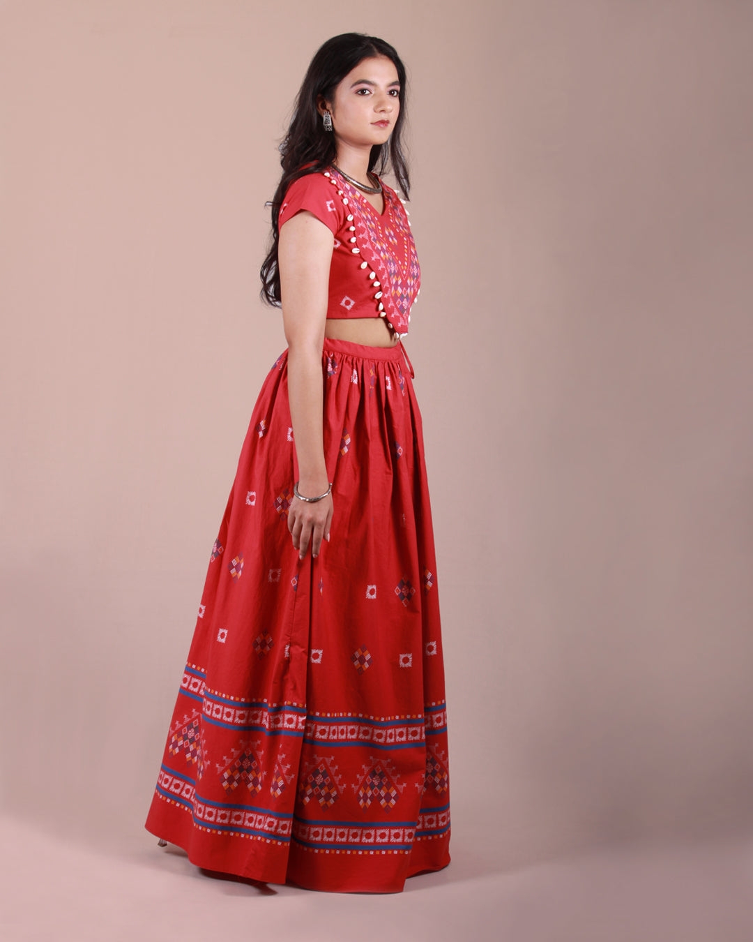 Full side front view of Red Lambada Co-ord Set in cotton with cap sleeves, playful tassel and shell details