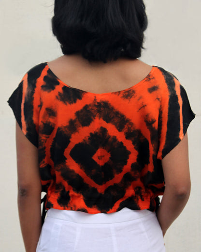 Back view of Tie Dye Orange Black Crop Top in cotton blend with drawstring detail at waist