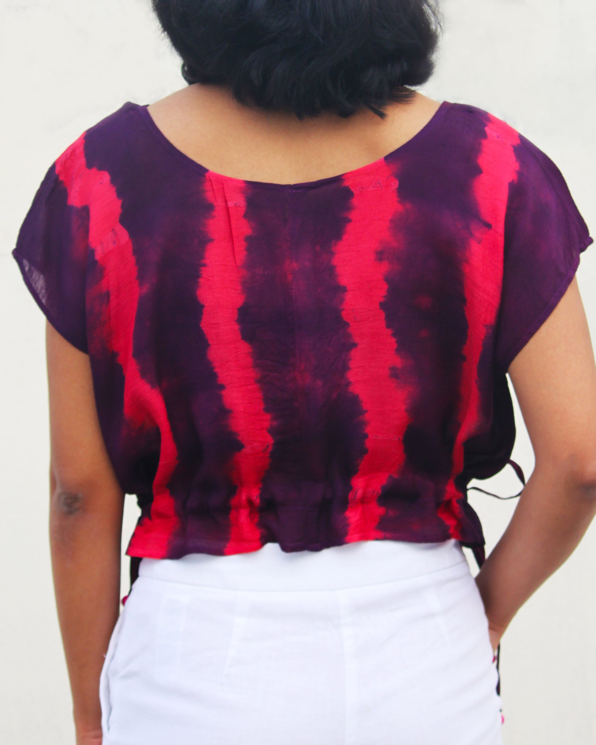 Back view of Tie Dye Pink Violet Crop Top in cotton blend with drawstring detail at waist