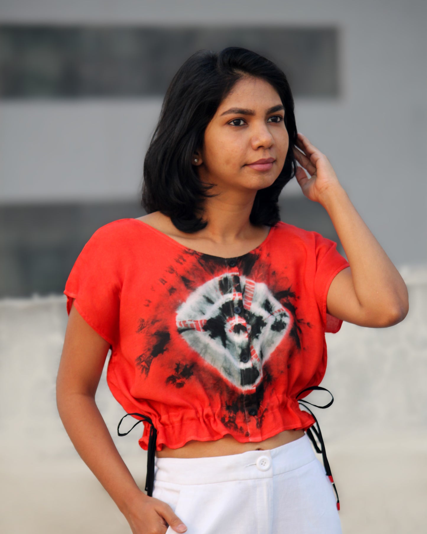 Front view of Tie Dye Red Black Crop Top in cotton blend with drawstring detail at waist