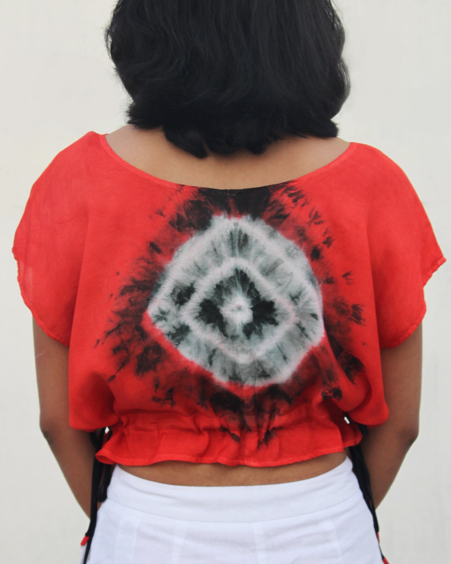 Back view of Tie Dye Red Black Crop Top in cotton blend with drawstring detail at waist