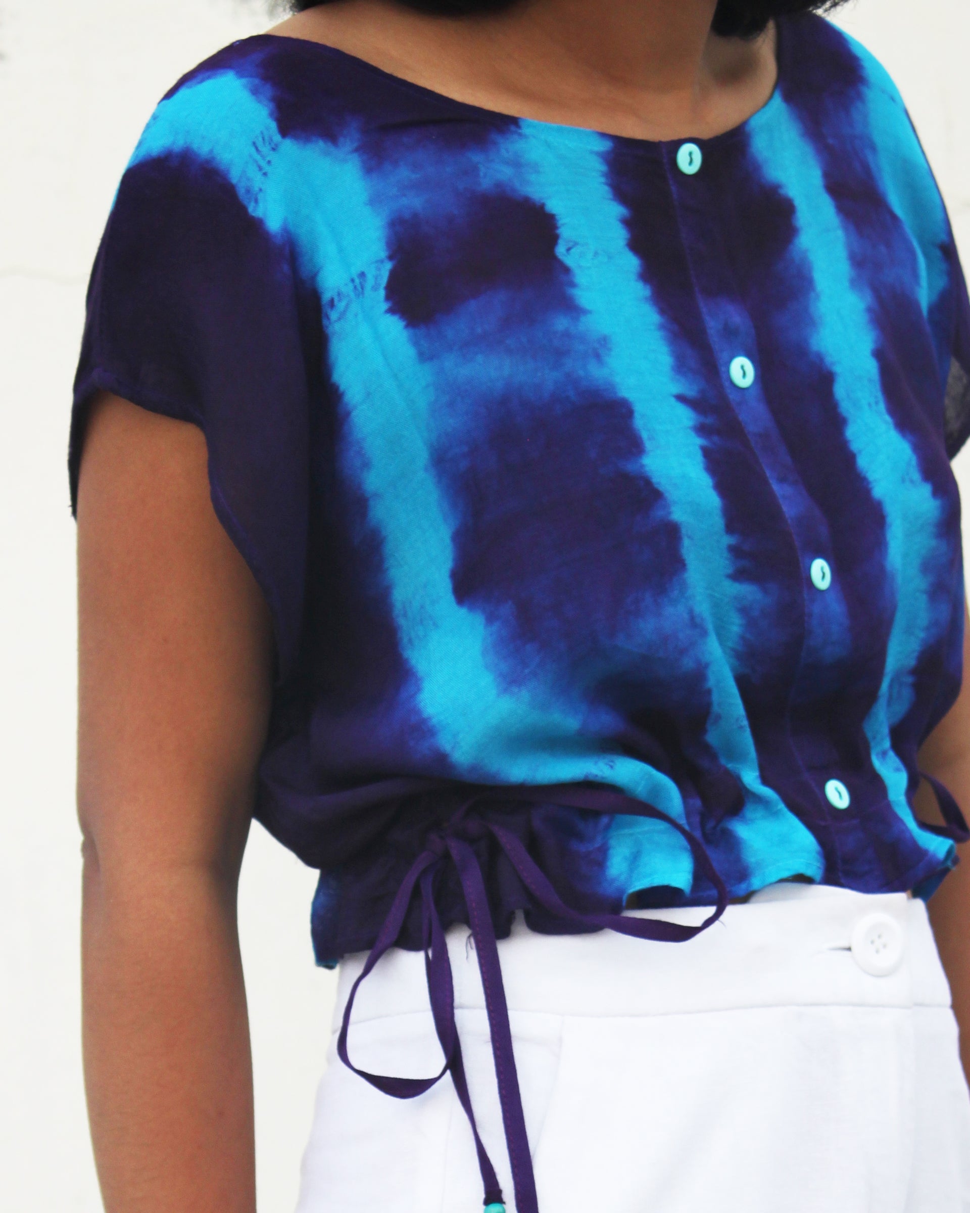 Side view of Tie Dye Blue Violet Crop Top in cotton blend with drawstring detail at waist