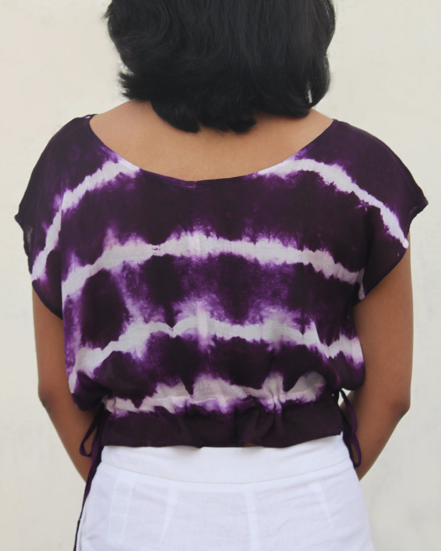 Back view of Tie Dye Violet White Crop Top in cotton blend with drawstring detail at waist