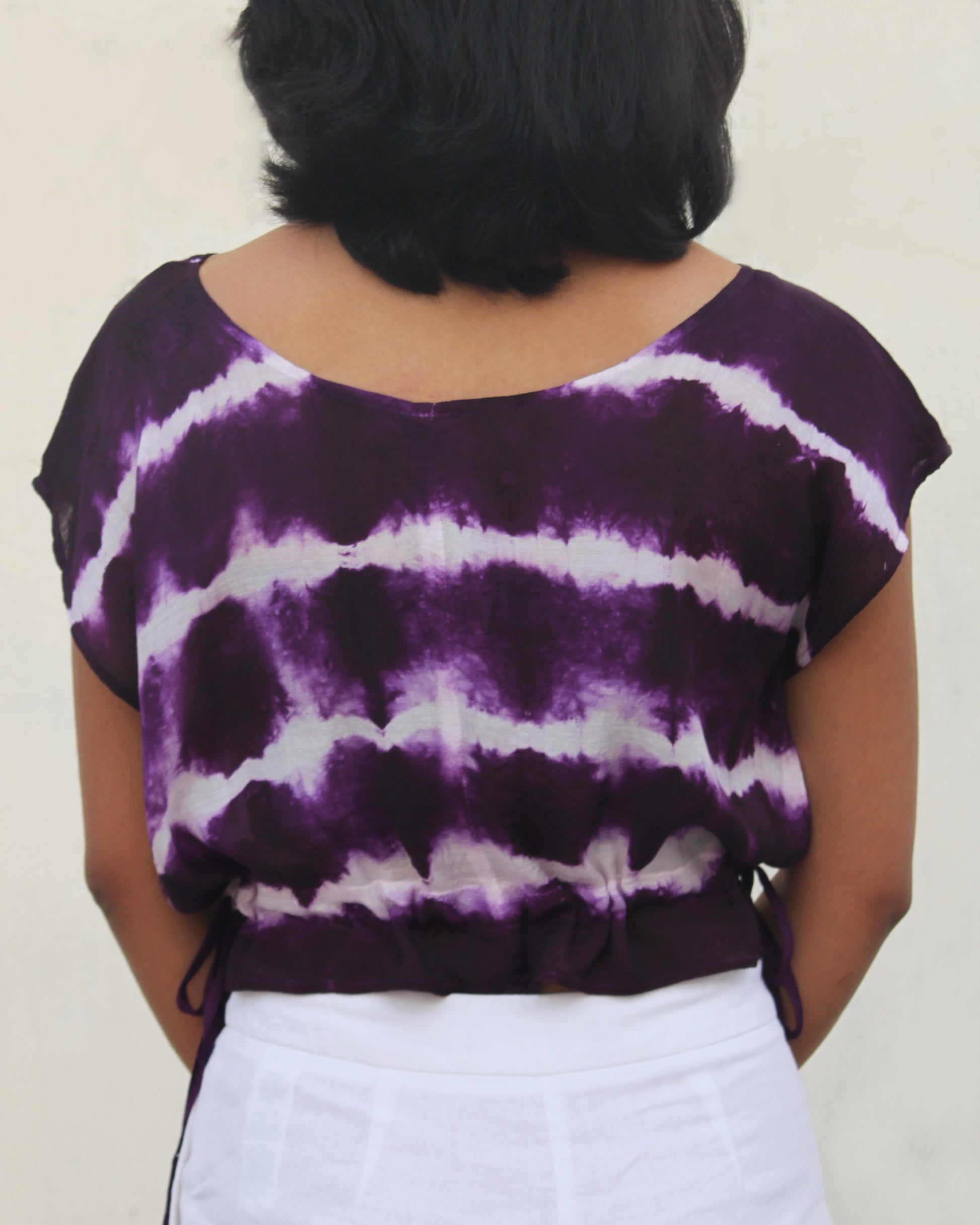 Back view of Tie Dye Violet White Crop Top in cotton blend with drawstring detail at waist