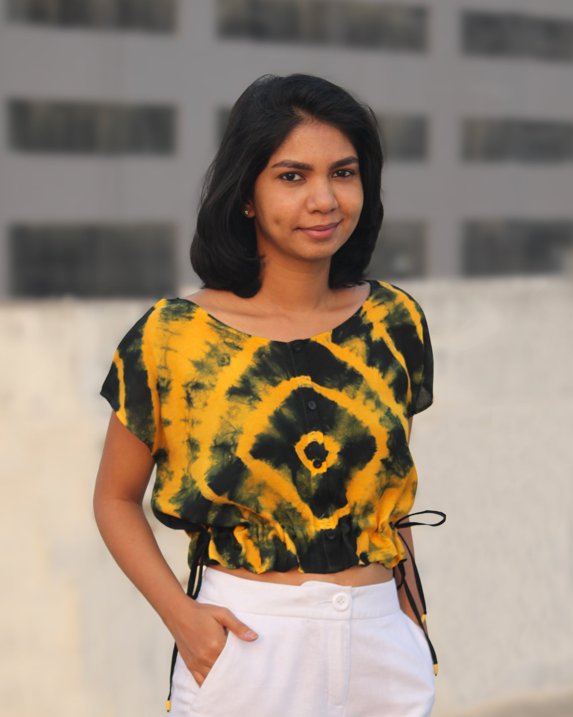 Front view of Tie Dye Yellow Black Crop Top in cotton blend with drawstring detail at waist