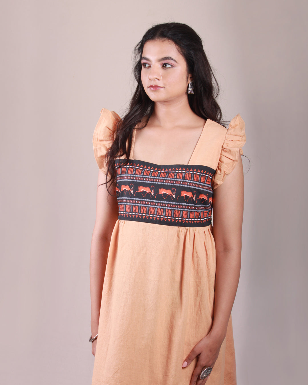 Closeup front view of Terracotta Midi Dress in cotton with drawstring details and flare sleeves