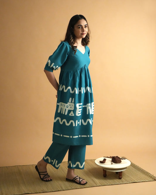 Side view of Polu Cotton Co-ord Set in teal blue with V-neck kurta, tribal prints, and wide-leg pants
