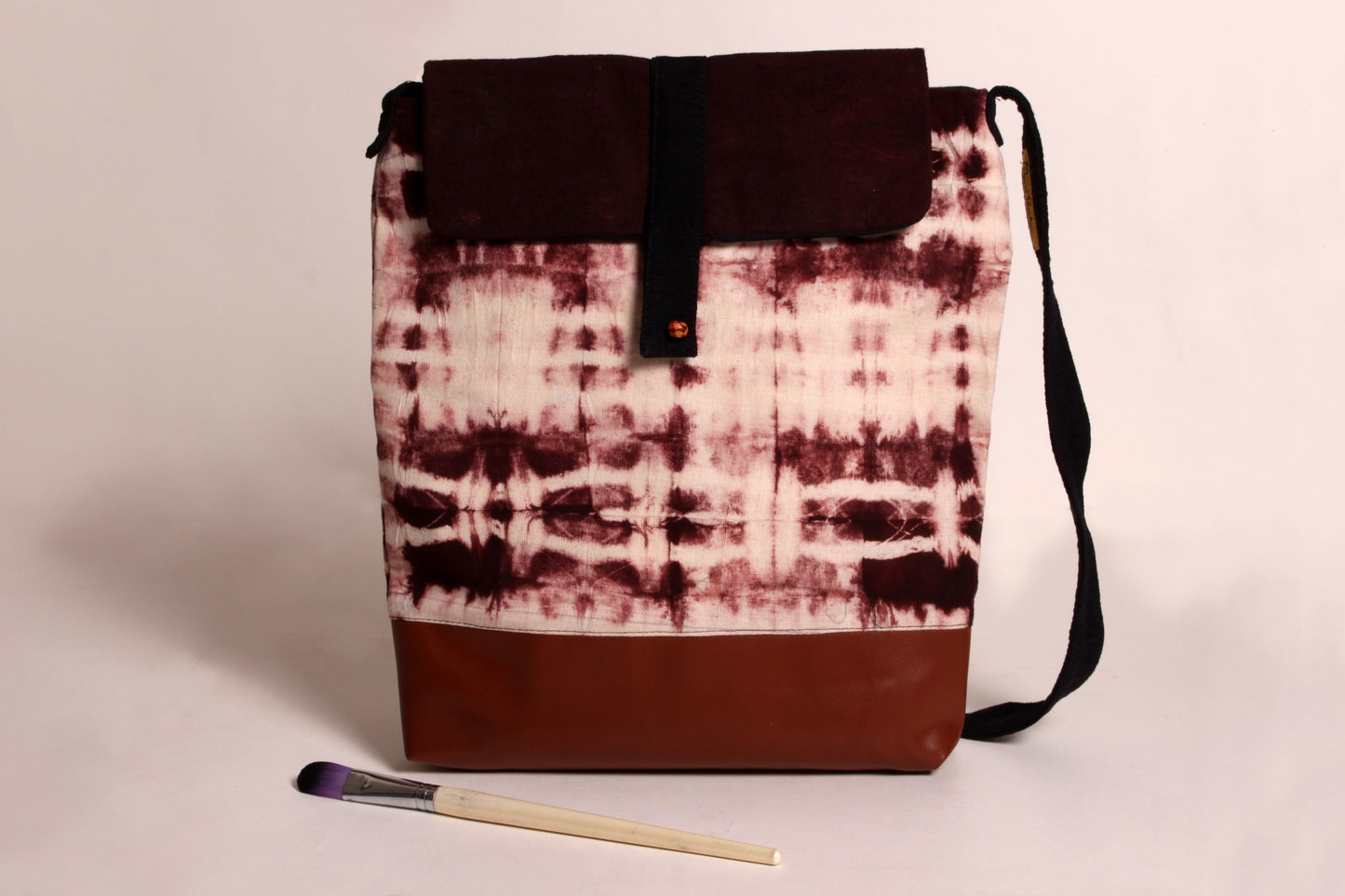 Front view of Earthy Brown Artist Bag made from cotton fabric with faux leather, a magnetic snap closure, and a pocket 