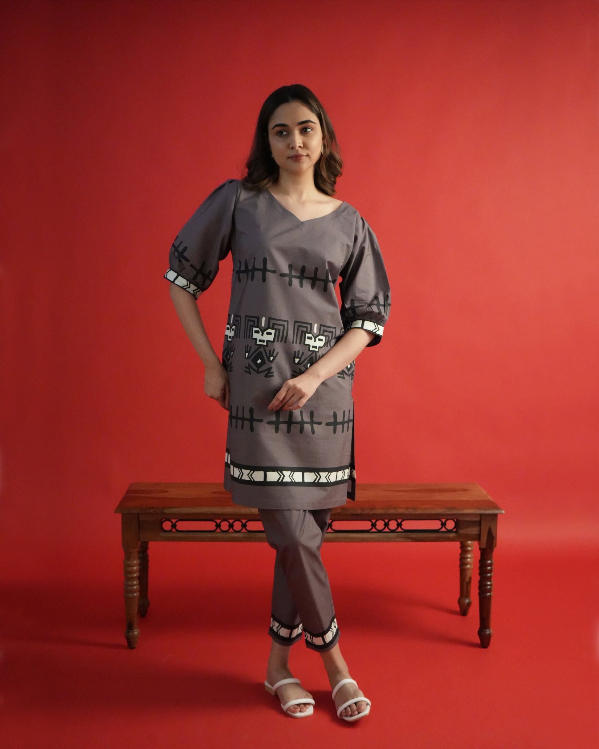 Front view of Tua Cotton Co-ord Set in rich brown with V-neck kurta, puffed sleeves, tribal motifs, and narrow pants