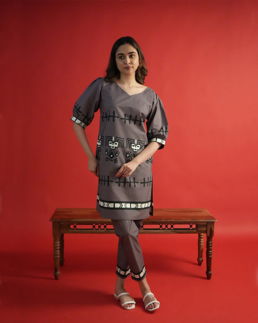 Front view of Tua Cotton Co-ord Set in rich brown with V-neck kurta, puffed sleeves, tribal motifs, and narrow pants