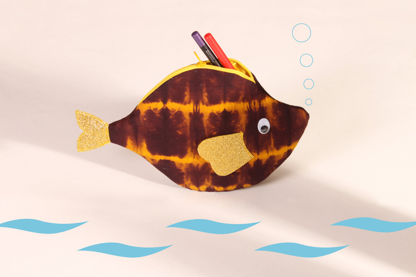 Side view of Brown Pomfret Fish Pouch made from cotton fabric showing makeup organised 