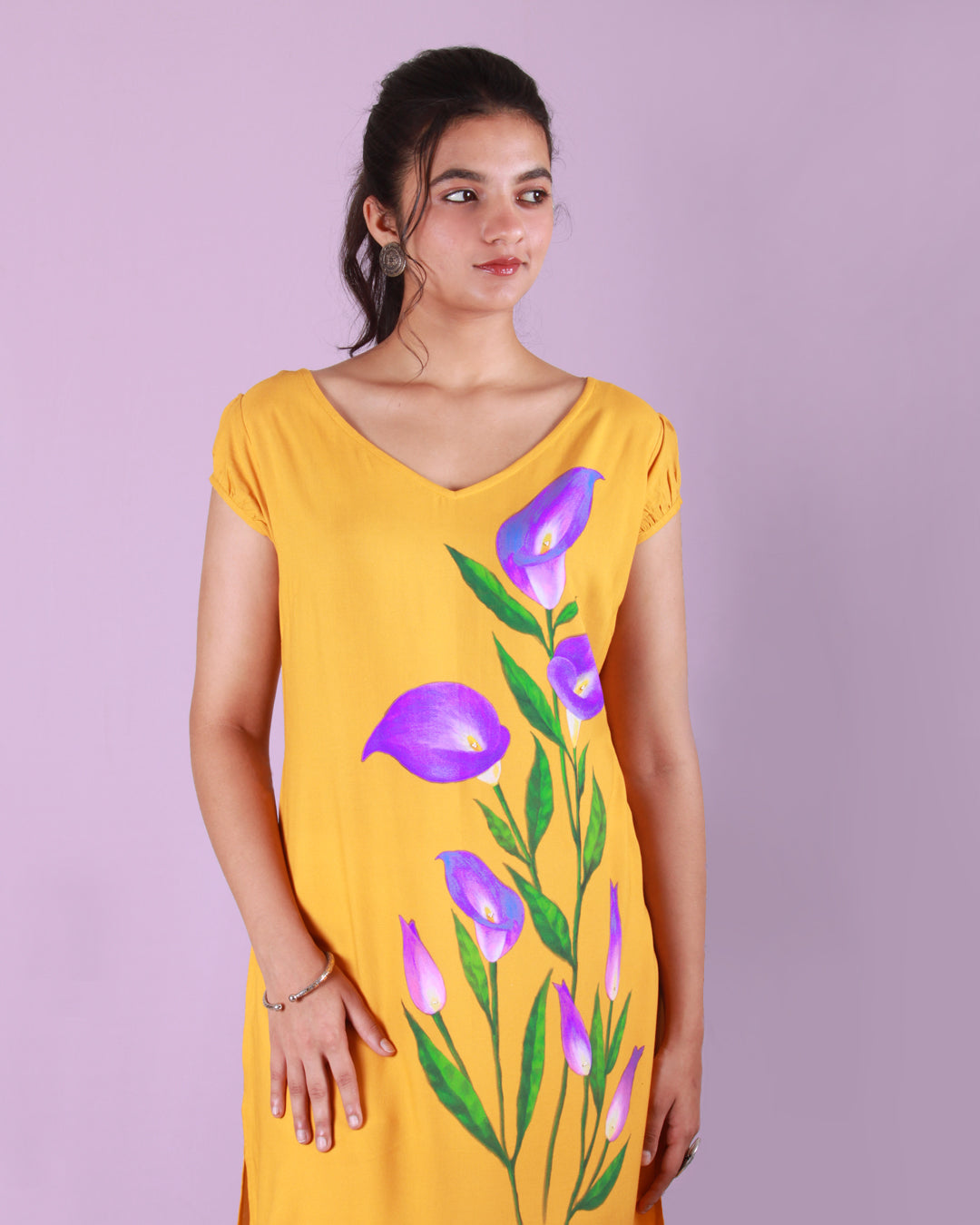 Front closeup of yellow Calla Lily Tunic in cotton blend with slight puff cap sleeves and drawstring detail